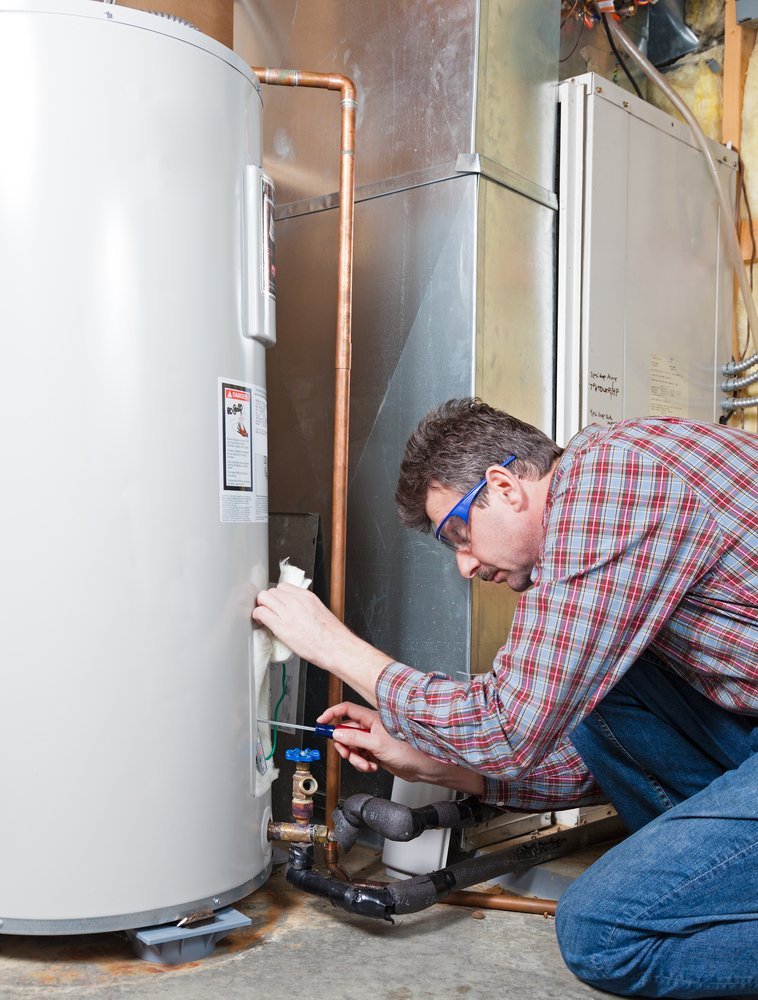 Plumber servicing a hot water heater unit